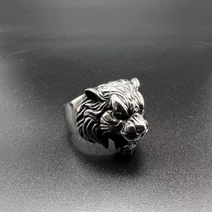 Macro shot of vintage silver tiger head ring showing detailed fur texture and roar design