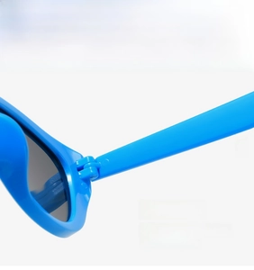 Close-up of durable metal hinge on bright blue retro sunglasses for smooth folding