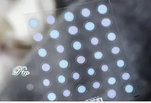 Macro shot of 5D ultra-thin nail art stickers TS-740 with 25 blue and purple round dots