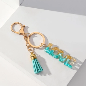 Love letter keychain with teal resin charms, tassels, and gold metal lobster clasp