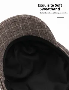 Detail of the soft cotton sweatband inside the brown plaid wool newsboy cap