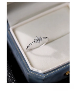 Macro shot of S925 sterling silver twist ring with zircon flower in luxury jewelry box