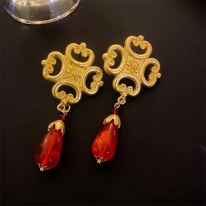 Vintage style gold earrings with red water-drop pendants and intricate oriental motifs