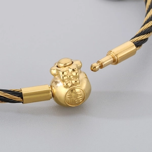 Makroaufnahme von 3mm geflochtenem Drahtarmband mit goldenem Glücksbeutel-Verschluss