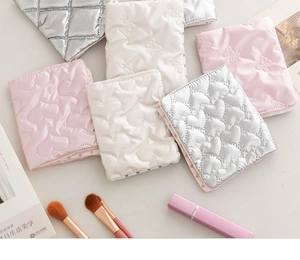 Quilted bow passport holder collection in pink, white, and silver with heart stitching