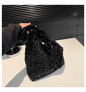 Detail shot of the black sequined fabric texture on a high-capacity commuter tote bag