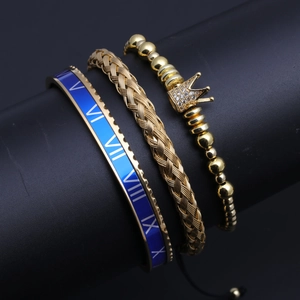 Detail of three-piece set with Roman numeral bangle, braided chain, and crown bracelet