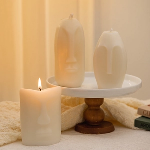 Artistic white facial sculpture candles made of plant wax in a warm lifestyle setting