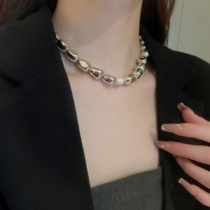 Irregular silver metal bead necklace with freshwater pearl accent on female model