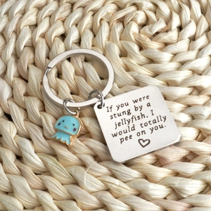 Macro view of stainless steel keychain with jellyfish charm and humor text plate