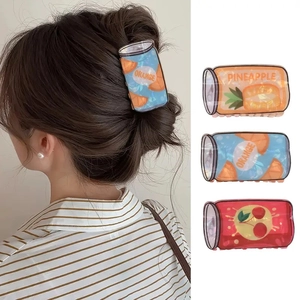 Detail of fruit drink can hair claws featuring orange pineapple and cherry designs