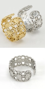 Detail of adjustable hollow flower ring set in gold and silver stainless steel