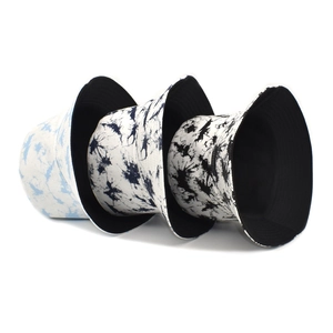 Reversible tie-dye bucket hats in blue cloud and black ink patterns for women