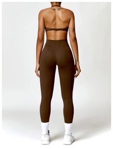 Detail of dark brown backless yoga top and high-waist leggings with push-up effect