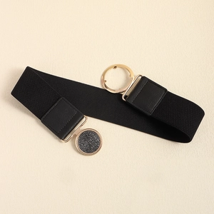 Detail of black elastic waist belt featuring a round gold buckle and faux leather tabs