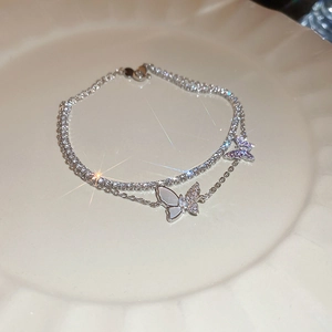 Detail of double-layer butterfly bracelet featuring sparkling zircon stones and shell inlay