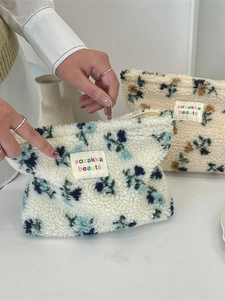 Floral plush makeup bag made of soft sherpa fabric with a sturdy zipper closure