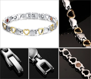 Detail view of two-tone stainless steel heart links with magnetic therapy inserts on inner band