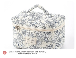 Detail of blue floral quilted cotton toiletry bag with zipper and decorative patch