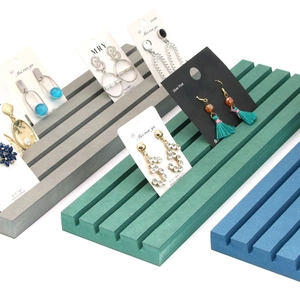 Three-color jewelry display stands in grey, cyan, and blue with parallel card slots