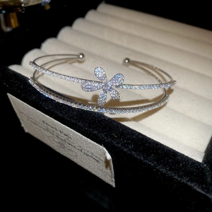 Close-up of double-layer silver flower bracelet with micro-pave zircons on black velvet