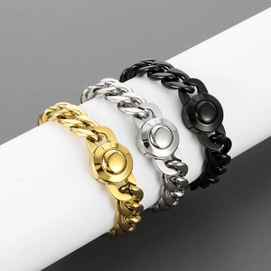 Three Cuban link chains in gold, silver, and black metal wrapped on a white cylinder