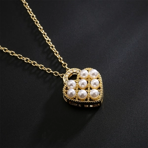 18K gold plated heart pendant necklace with pearls and zircons on black background