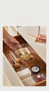 Macro shot of transparent drawer organizers for makeup and cosmetics storage in a drawer