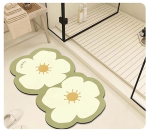 Detail view of the thick double sunflower bathroom mat with FANCY text on soft plush surface