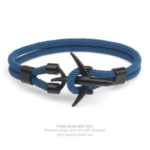 Detail of hand-knitted blue Milan rope bracelet with a matte black aircraft shaped clasp