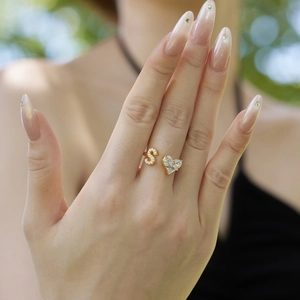Close-up of adjustable gold S925 silver ring with zircon heart and S letter on finger