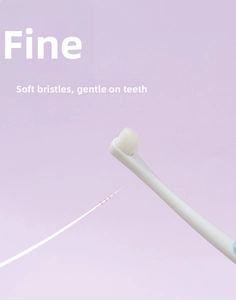 Detailed macro view showing the ultra-fine soft white bristles of the pet toothbrush