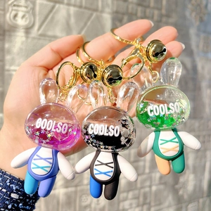 Acrylic quicksand bunny keychain in pink black and green with star sequins