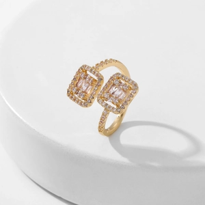 Exaggerated bypass ring with square pink zircons in gold-plated copper setting