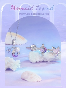 Close-up of mermaid tail pendant and beaded bracelet on white coral in dreamlike scenery