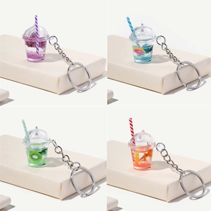 Luminous fruit milk tea cup keychains in four colors with floating fruit slices