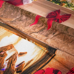 Close-up detail of soft flannel Christmas tapestry showing vivid fireplace and stocking prints