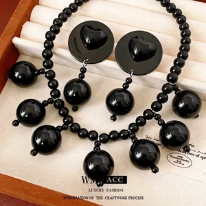 Elegant black acrylic beaded necklace and heart embossed stud earrings jewelry set