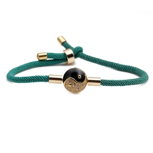 Green woven Tai Chi bracelet with gold-tone Yin Yang charm and adjustable drawstring cord