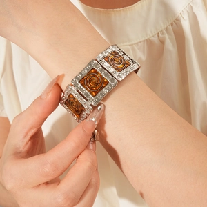 Detail of vintage enamel square link bracelet in antique silver on model's wrist