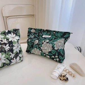 Vintage floral jacquard makeup bag with green and white embroidery on black fabric