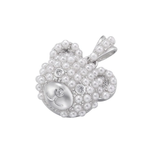 Close-up of cute bear pendant inlaid with white pearls and sparkling rhinestones