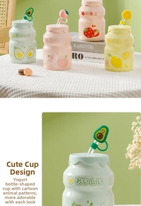 Detail of yogurt-bottle-shaped ceramic mugs with silicone straw caps and fruit patterns