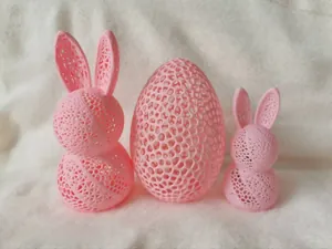 Detailed view of pink 3D printed Easter bunny and egg with Voronoi hollow geometric pattern