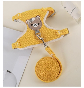 Detail of yellow fabric pet harness set featuring cute bear patch and durable leash