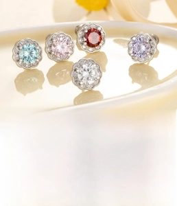 Macro detail of zircon flower studs with titanium steel screw back and size specs