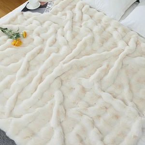 Macro view of plush cream faux rabbit fur blanket with wavy 3D embossed texture