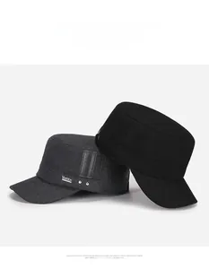 Detail view of winter wool military caps with metal V logos in dark grey and black