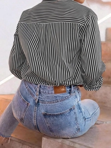 Women's casual black and white striped long sleeve shirt with pleated back design and jeans