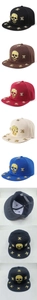 Detail of hip hop snapback hats featuring gold skull metal studs in multiple colors